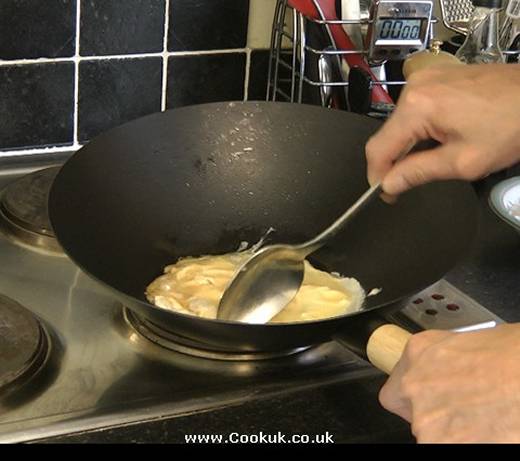 Fry egg in a wok